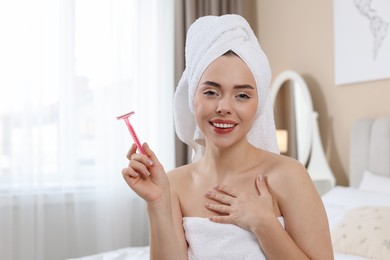 Photo of Happy woman with razor at home, space for text. Hair removal tool