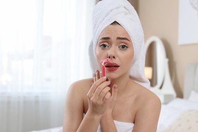 Photo of Emotional woman shaving her mustache with razor at home. Space for text