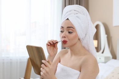 Photo of Beautiful woman plucking her mustache with tweezers at home