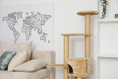 Photo of Stylish cat tree and sofa in living room