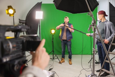 Photo of Group of people working in modern film studio, selective focus