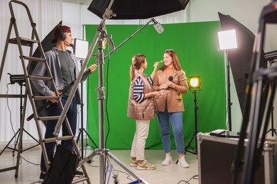 Photo of Group of people working in modern film studio