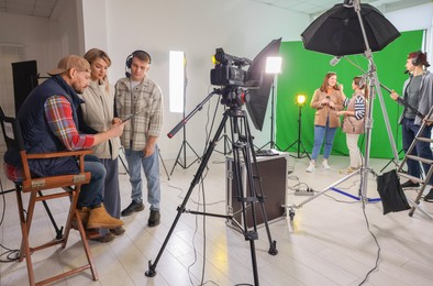 Photo of Group of people working in modern film studio