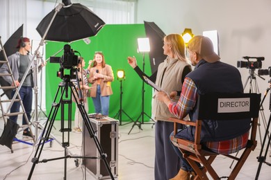 Photo of Group of people working in modern film studio