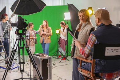 Photo of Group of people working in modern film studio