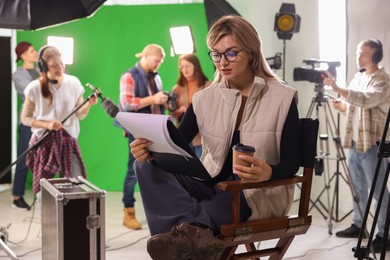 Photo of Group of people working in modern film studio