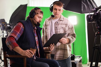 Photo of Men working with professional equipment in modern film studio