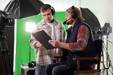 Photo of Men working with professional equipment in modern film studio