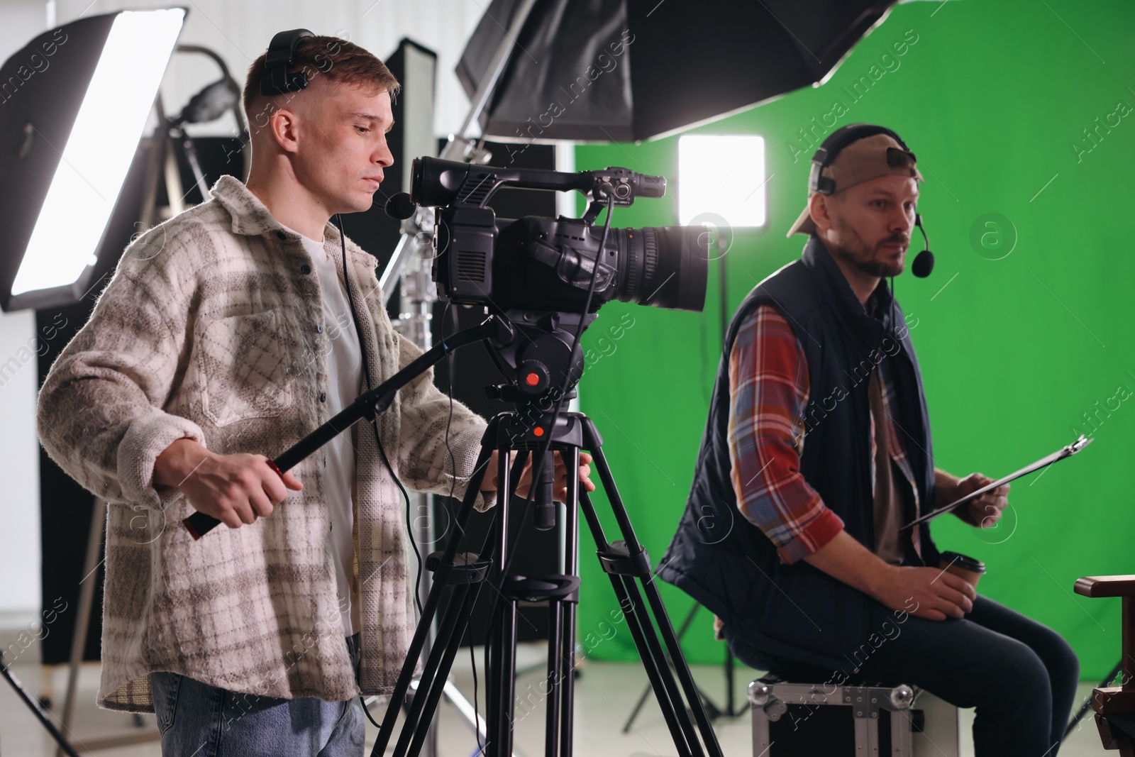 Photo of Men working with professional equipment in modern film studio