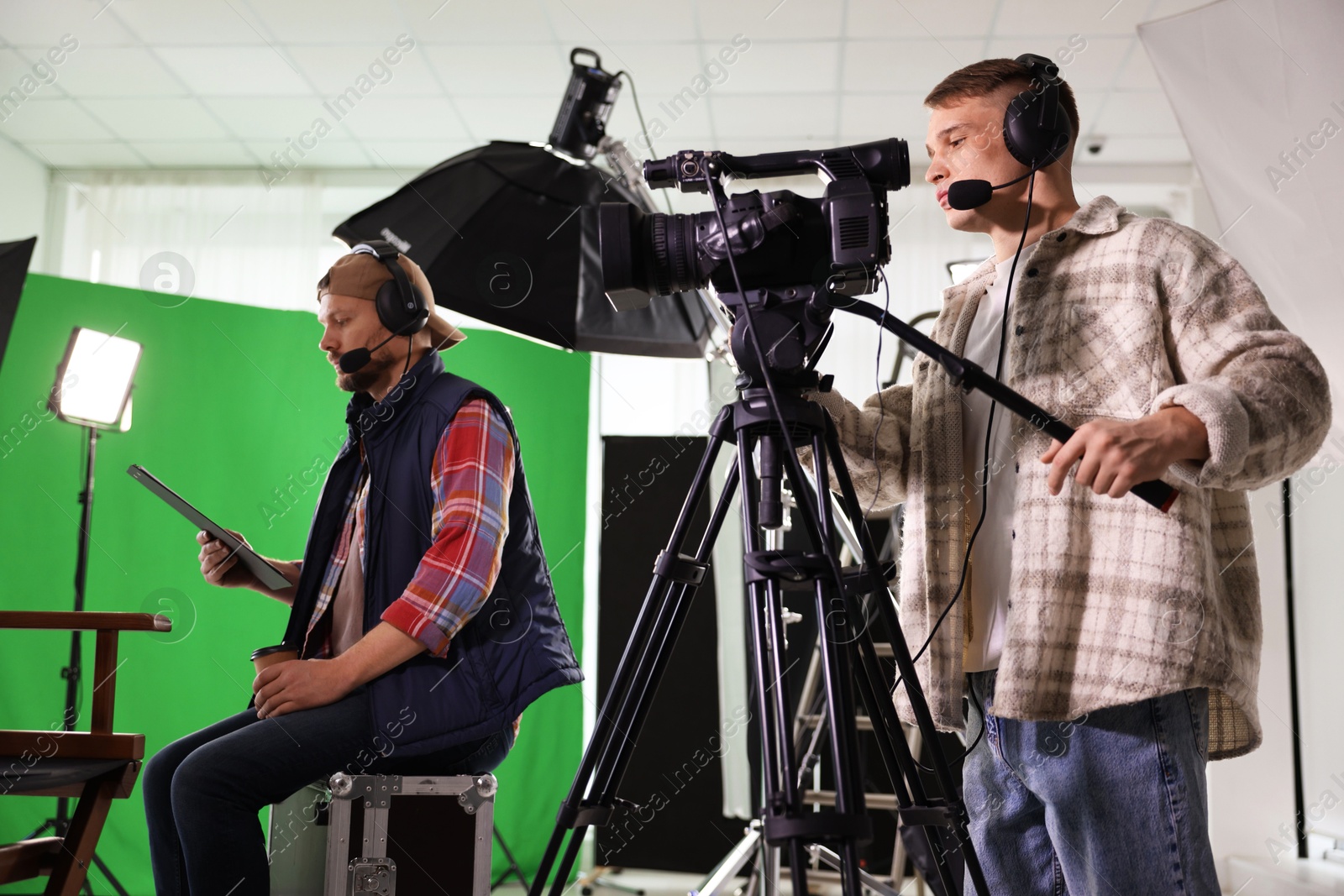 Photo of Men working with professional equipment in modern film studio