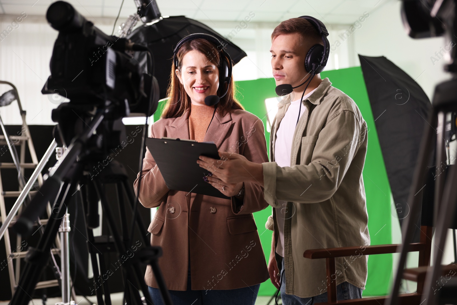 Photo of Man and woman working in modern film studio