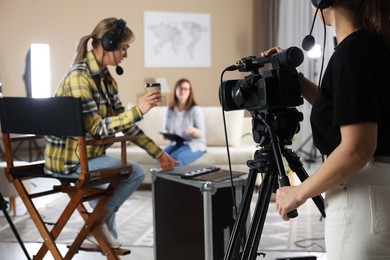 Photo of Group of people working in modern film studio, selective focus