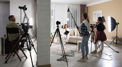 Photo of Group of people working in modern film studio