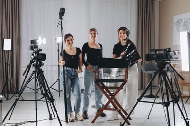 Photo of Group of people working in modern professional film studio