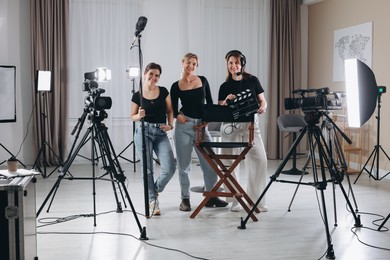 Photo of Group of people working in modern professional film studio