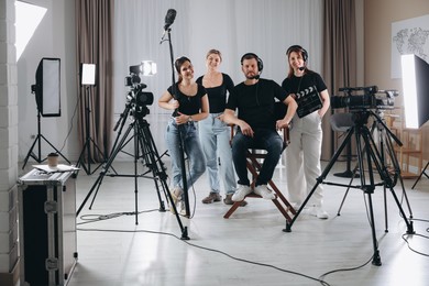 Photo of Group of people working in modern professional film studio