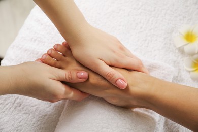 Photo of Woman receiving foot massage in spa salon, above view