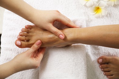 Photo of Woman receiving foot massage in spa salon, above view