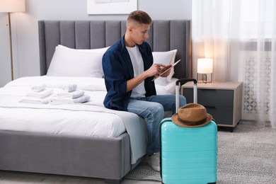 Photo of Man with tablet in his hotel room