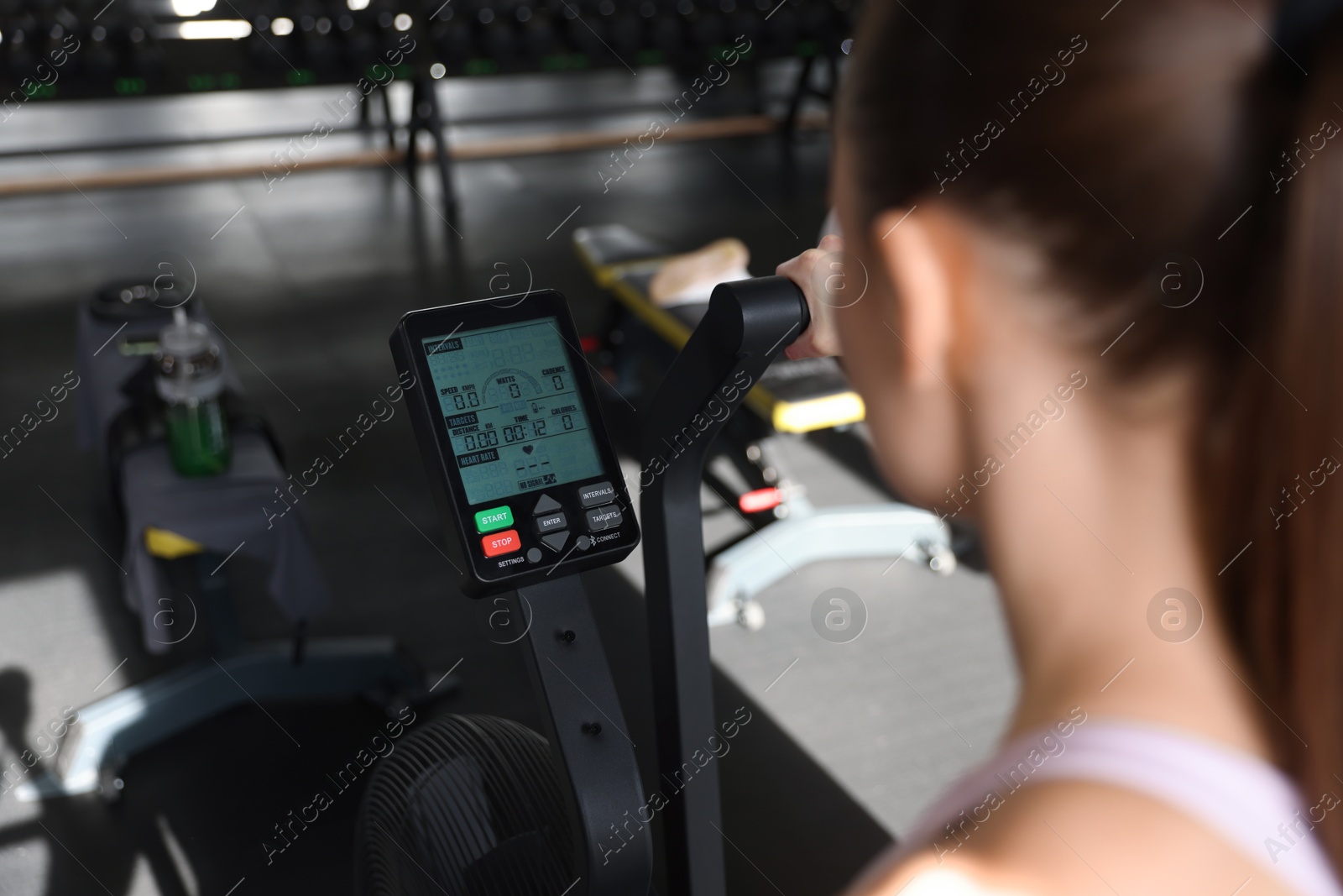 Photo of Woman training in gym, focus on exercise bike