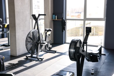 Photo of Professional equipment near window in sport gym