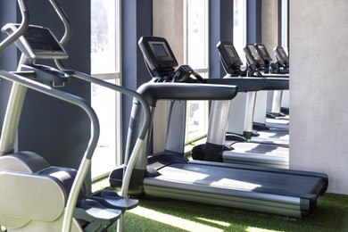 Photo of Different many treadmills in gym. Sport equipment