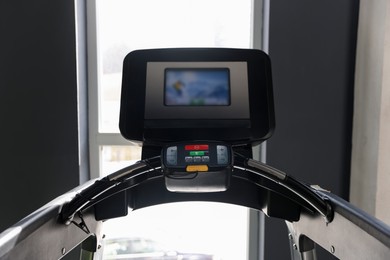 Photo of One treadmill with display in gym. Sports equipment