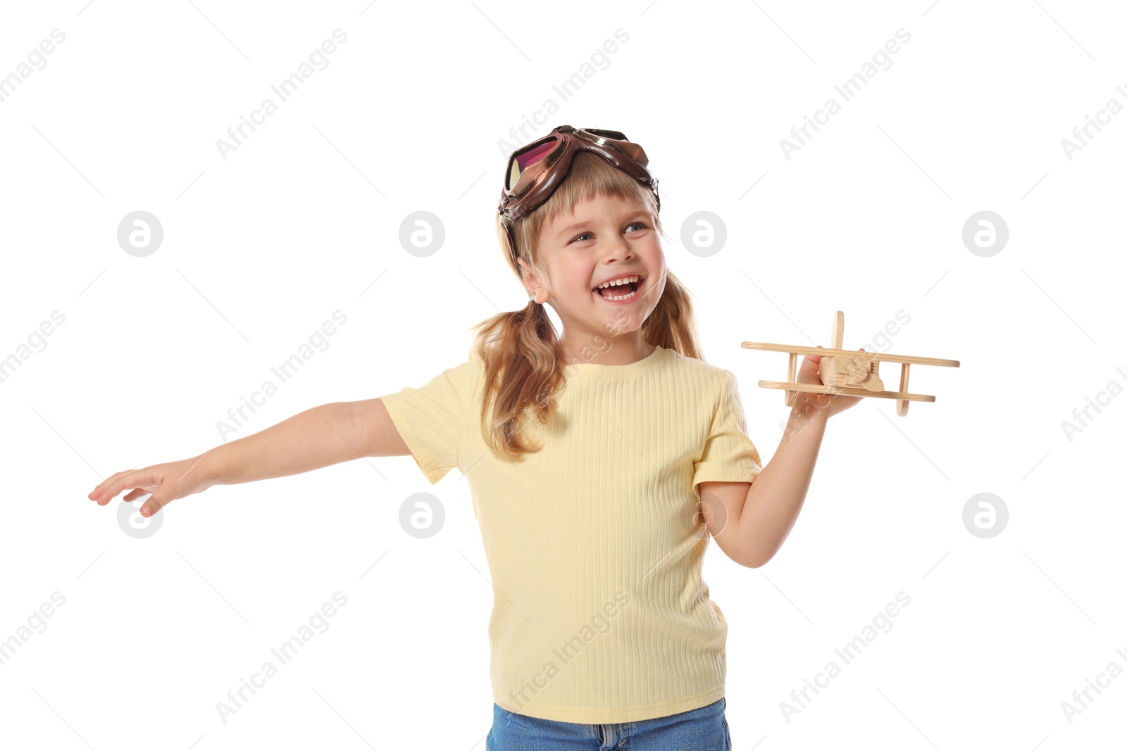 Photo of Happy little girl playing with toy plane on white background