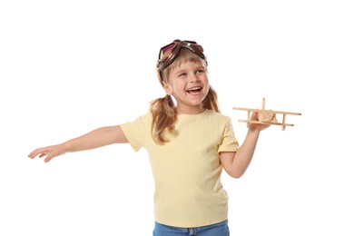 Photo of Happy little girl playing with toy plane on white background