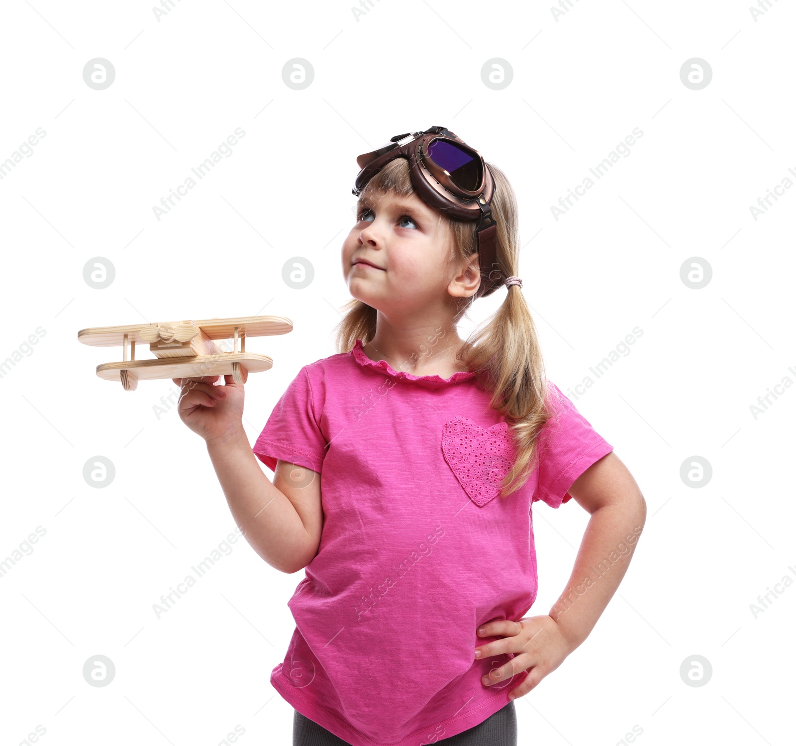 Photo of Cute little girl playing with toy plane on white background