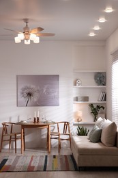 Photo of Stylish table setting, chairs and sofa in dining room. interior design