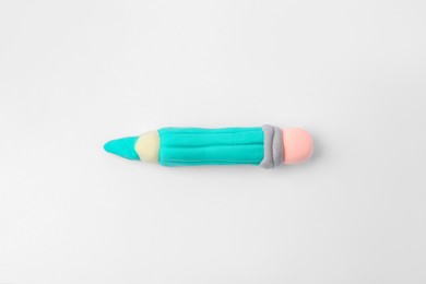 Photo of Pencil made from play dough on light grey background, top view