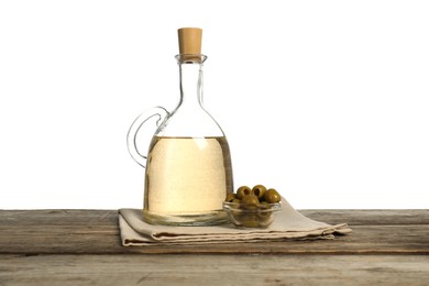 Photo of Vinegar and olives on wooden table against white background