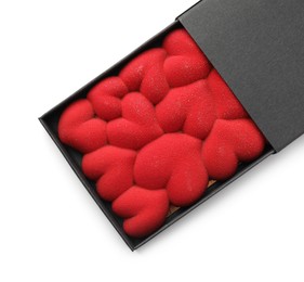 Photo of Chocolate bar decorated with hearts in box isolated on white, top view