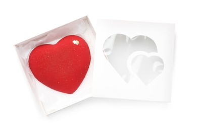 Photo of Heart shaped chocolate in box isolated on white, top view