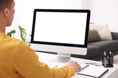 Photo of Man working on computer at white desk in office, closeup. Mockup for design