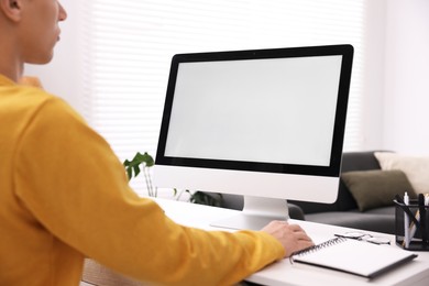 Photo of Man working on computer at white desk in office, closeup. Mockup for design