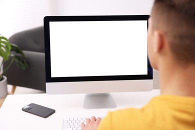 Photo of Man working on computer at white desk in office, closeup. Mockup for design