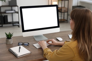 Photo of Woman working on computer at wooden desk in office. Mockup for design