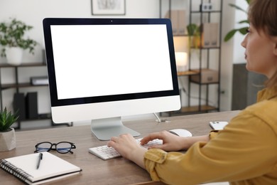 Photo of Woman working on computer at wooden desk in office. Mockup for design