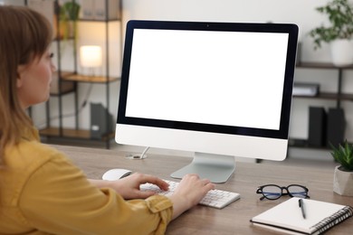 Photo of Woman working on computer at wooden desk in office. Mockup for design