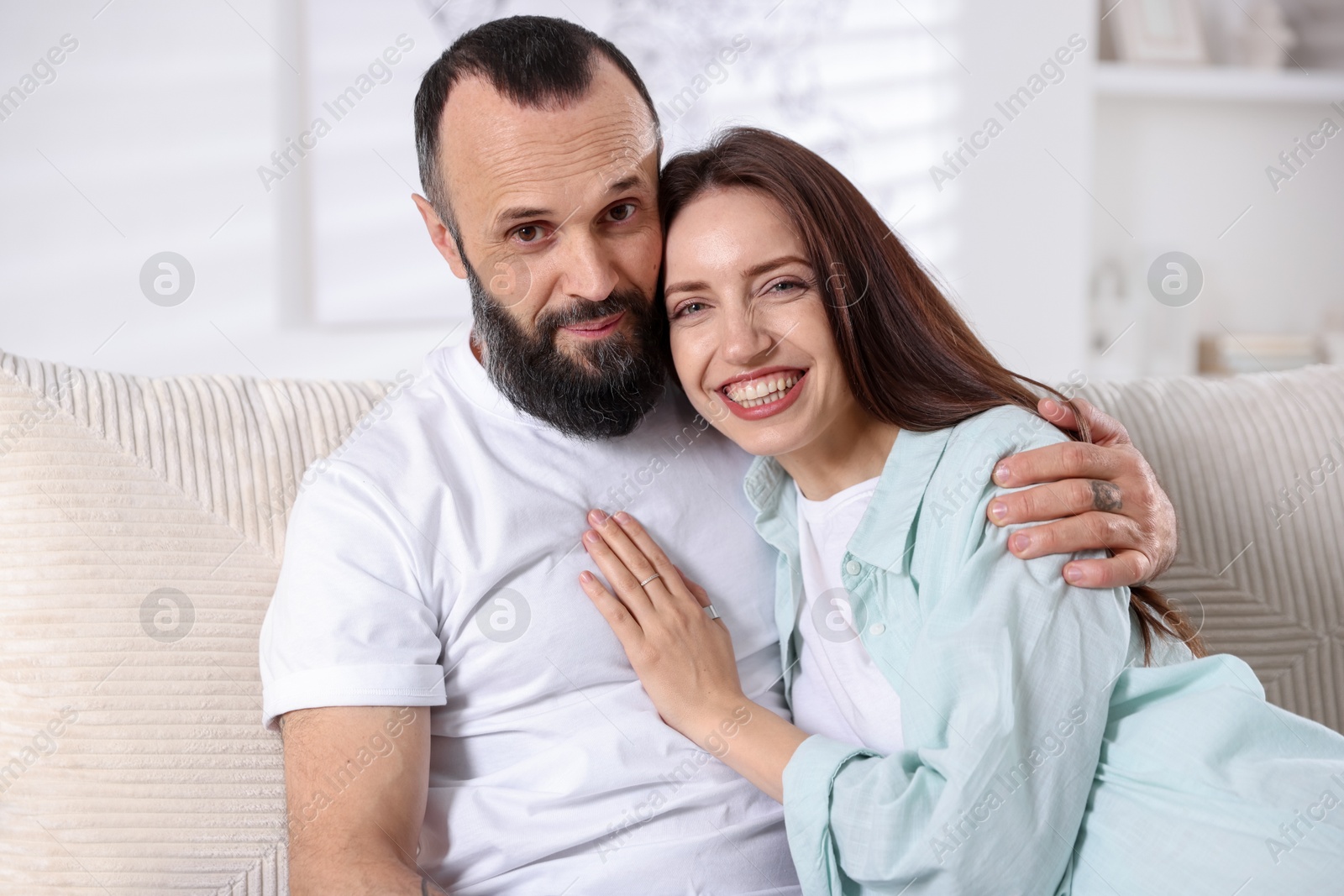 Photo of Portrait of happy daughter and father on sofa at home