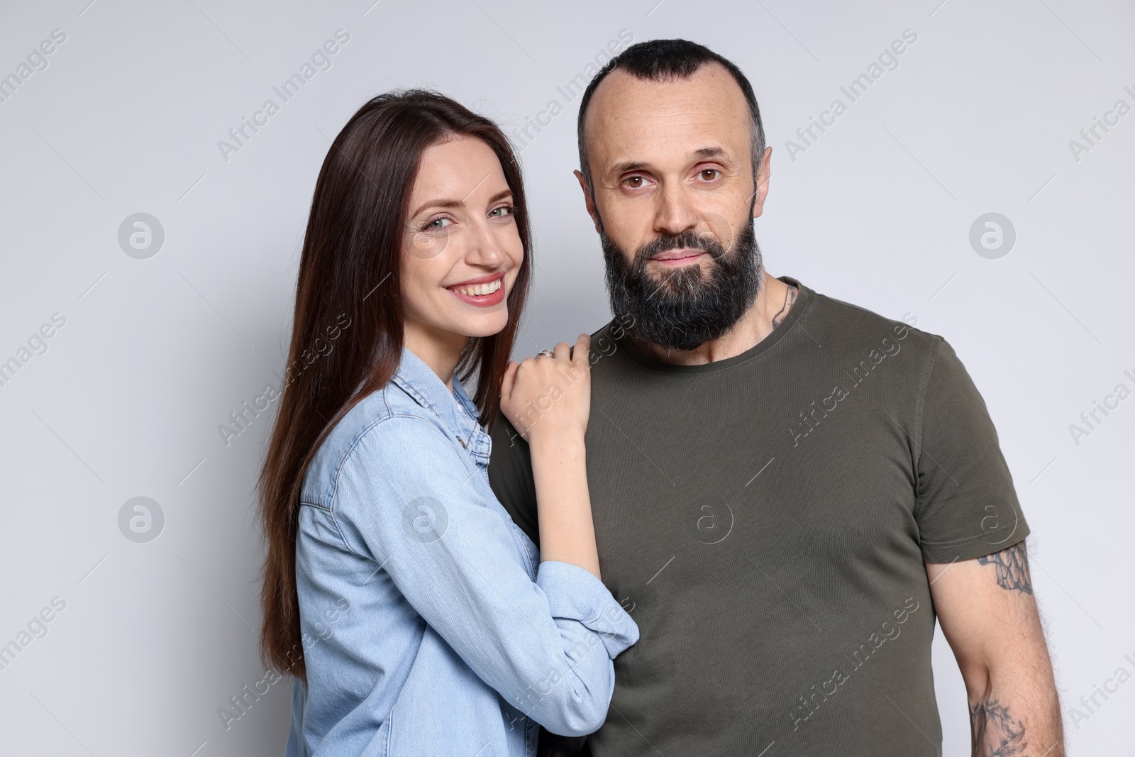 Photo of Portrait of happy daughter and father on light grey background