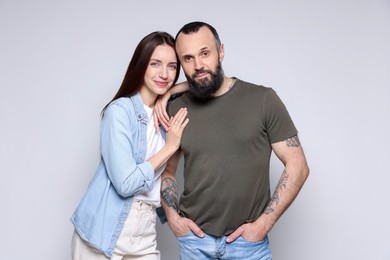 Photo of Portrait of happy daughter and father on light grey background