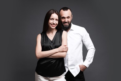 Photo of Portrait of happy daughter and father on dark grey background