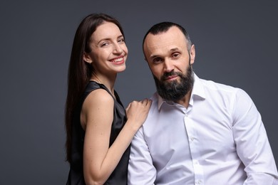 Photo of Portrait of happy daughter and father on dark grey background