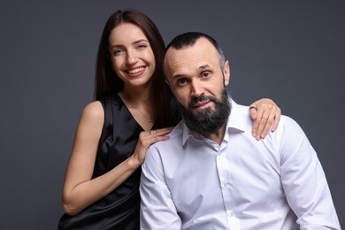 Photo of Portrait of happy daughter and father on dark grey background