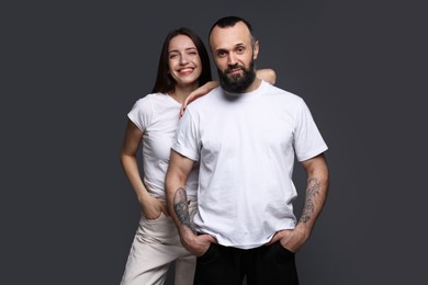 Photo of Portrait of happy daughter and father on dark grey background