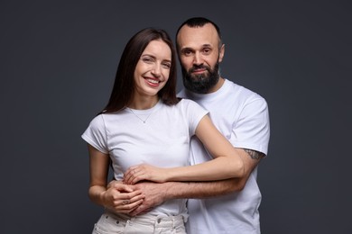 Photo of Portrait of happy daughter and father on dark grey background