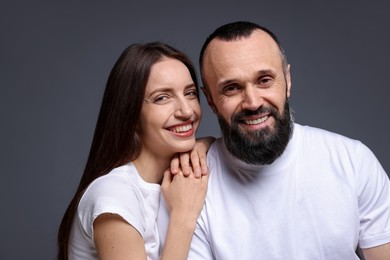 Photo of Portrait of happy daughter and father on dark grey background